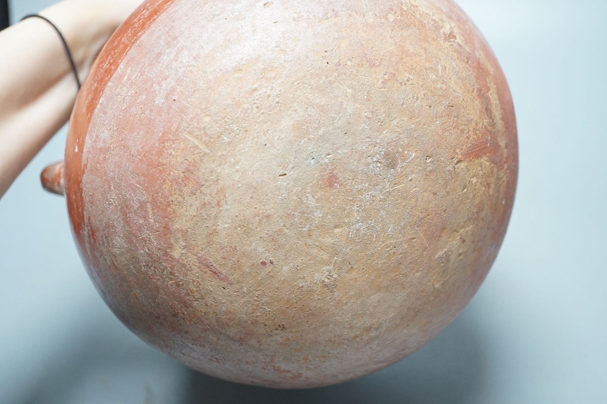 A pre-Columbian black and red pigment decorated two handled pot 25cm